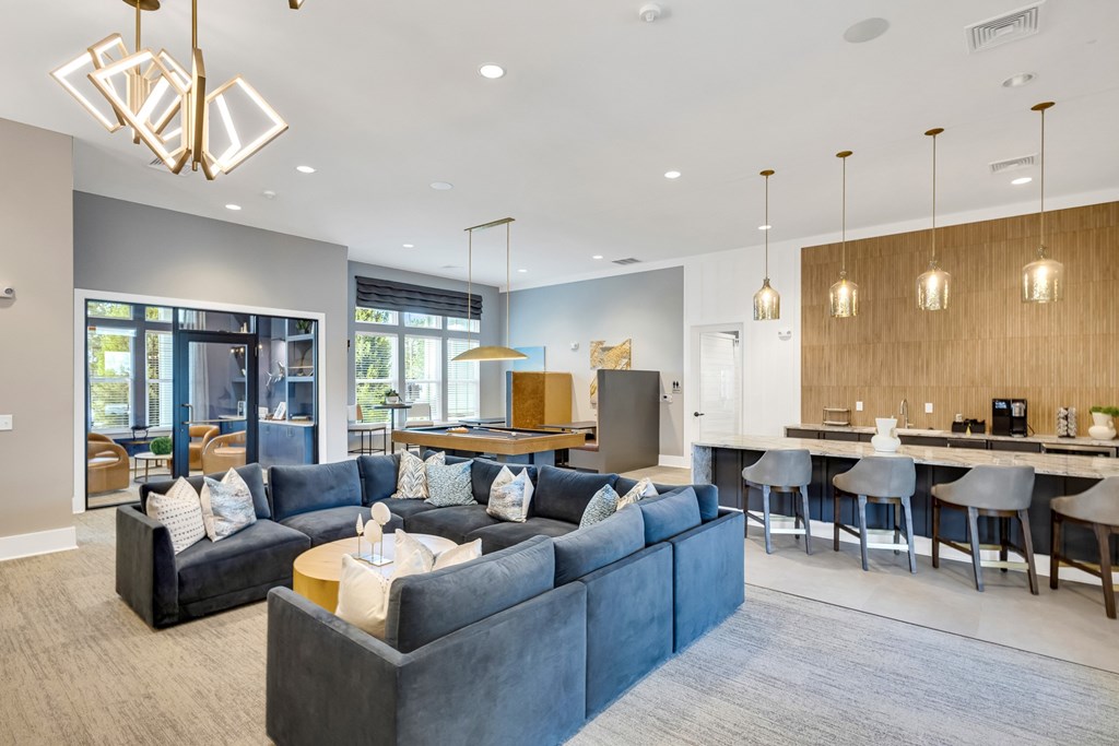 A modern living room with a grey sofa and a wooden coffee table.
