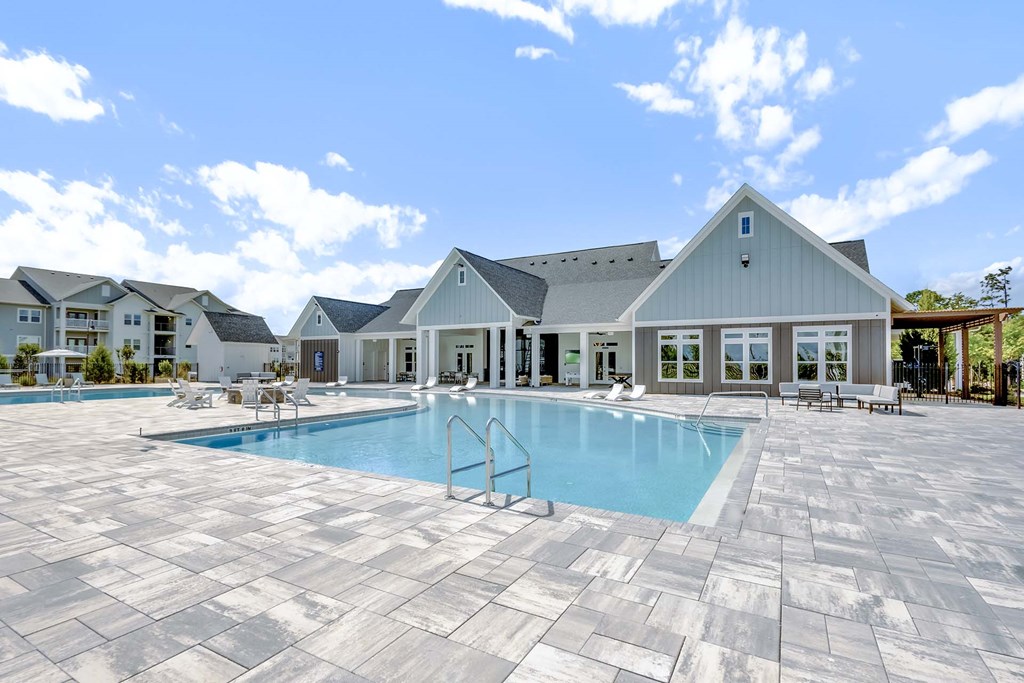 A large house with a pool in front.