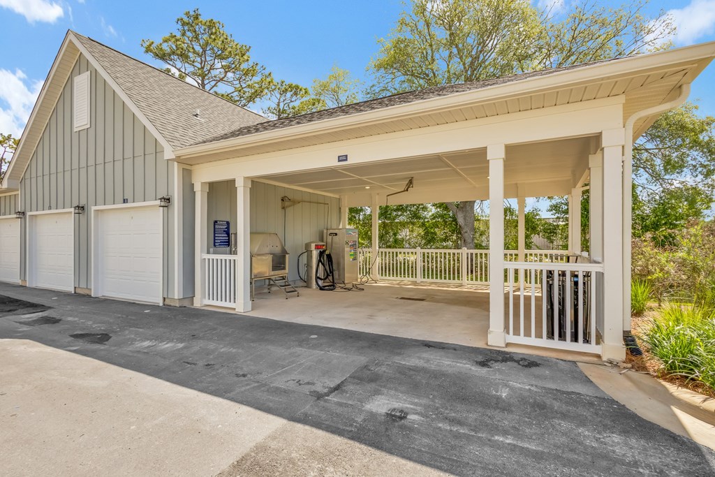 A garage with a white door and a black roof.