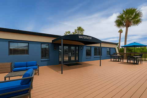 A building with a sign that says Waterview sits on a patio with blue chairs and a table.