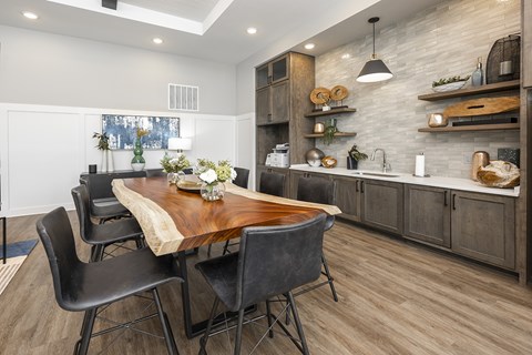 A modern kitchen with a dining table and chairs.