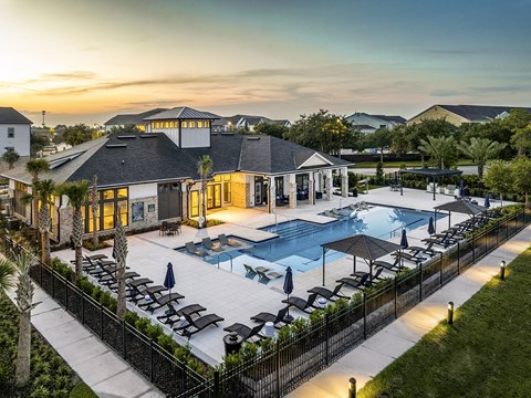 A luxurious resort with a swimming pool and lounging area.