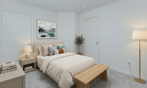 A bedroom with a bed, nightstands, and a painting on the wall.
