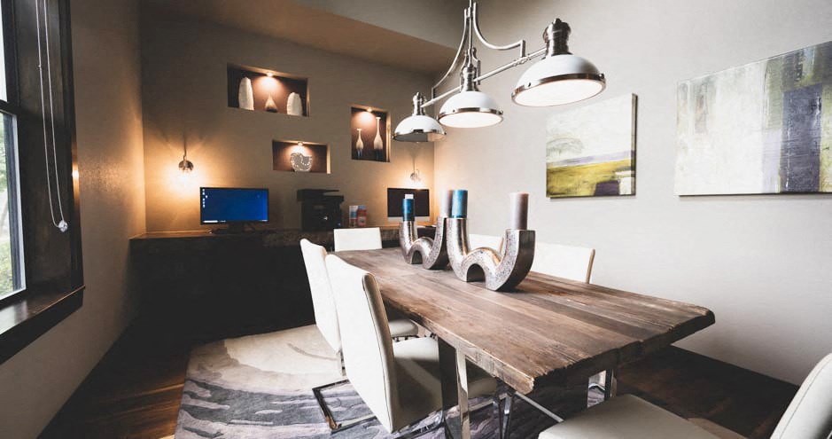 a dining room with a wooden table and white chairs