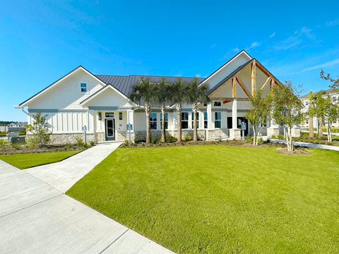 A modern house with a white exterior and a black roof.