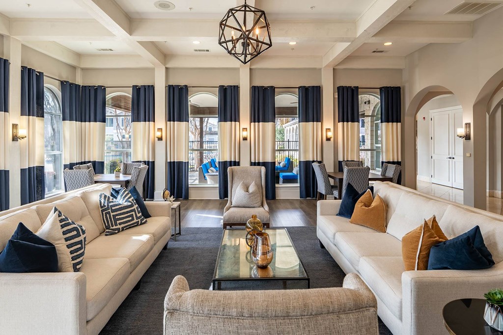 a living room with couches and chairs and a table  at Orion Prosper Lakes, Texas, 75078