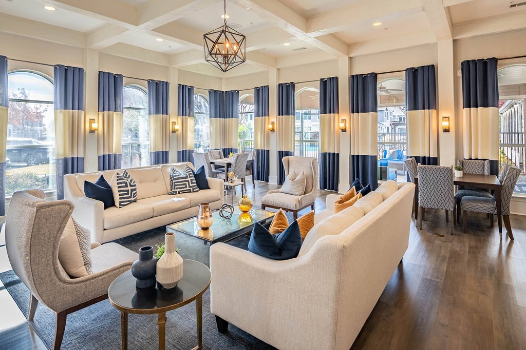 a living room with couches and chairs and a table  at Orion Prosper Lakes, Texas