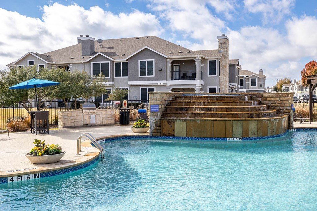 a swimming pool with a house in the background  at Orion Prosper Lakes, Prosper, Texas