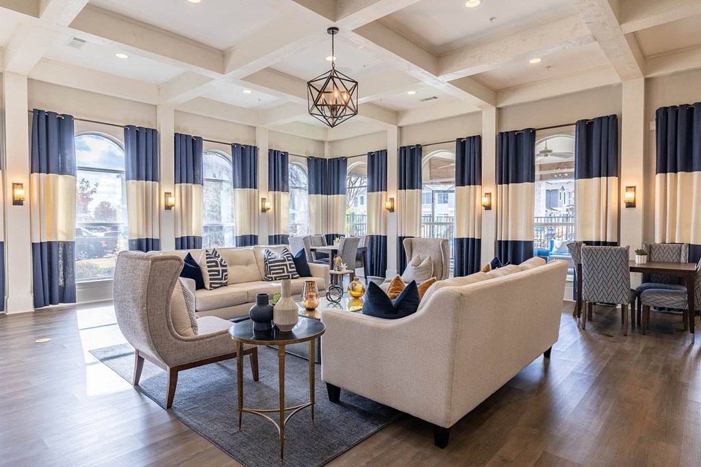a living room with couches and chairs and a table  at Orion Prosper Lakes, Texas