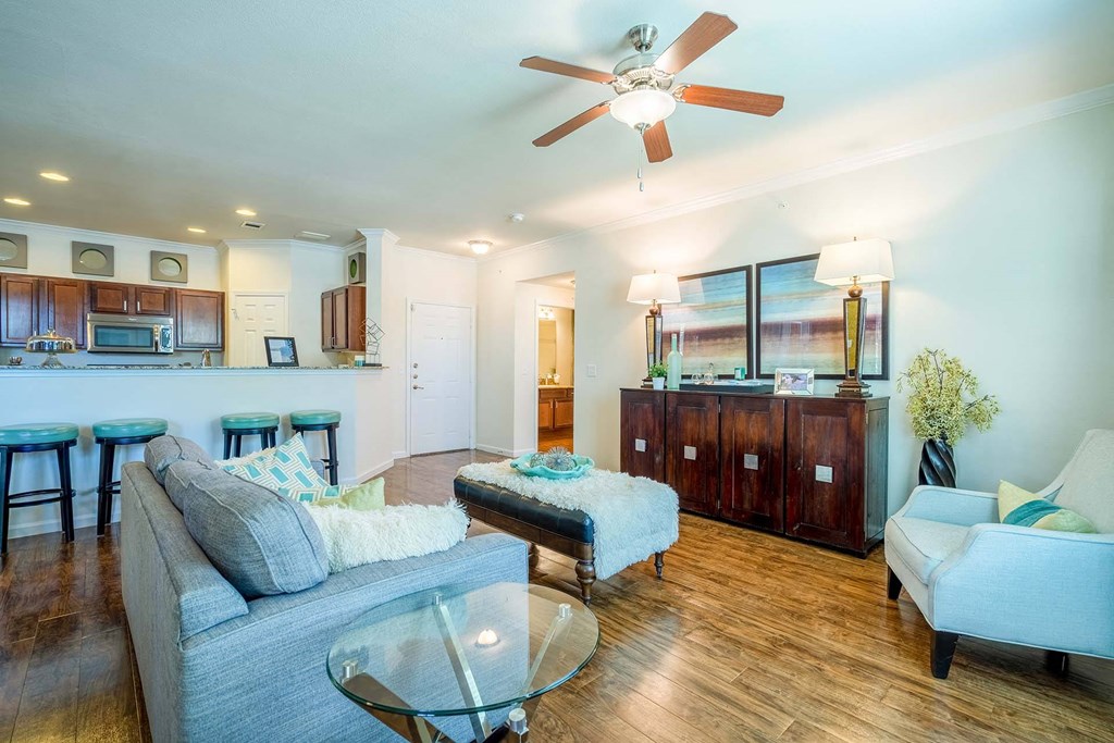 a living room with a couch and a chair  at Orion Prosper, Prosper, TX