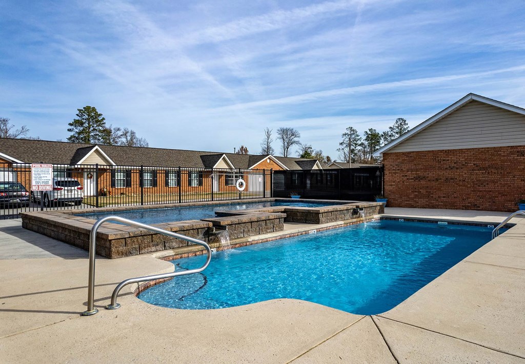 the swimming pool at the whispering winds apartments in pearland, tx