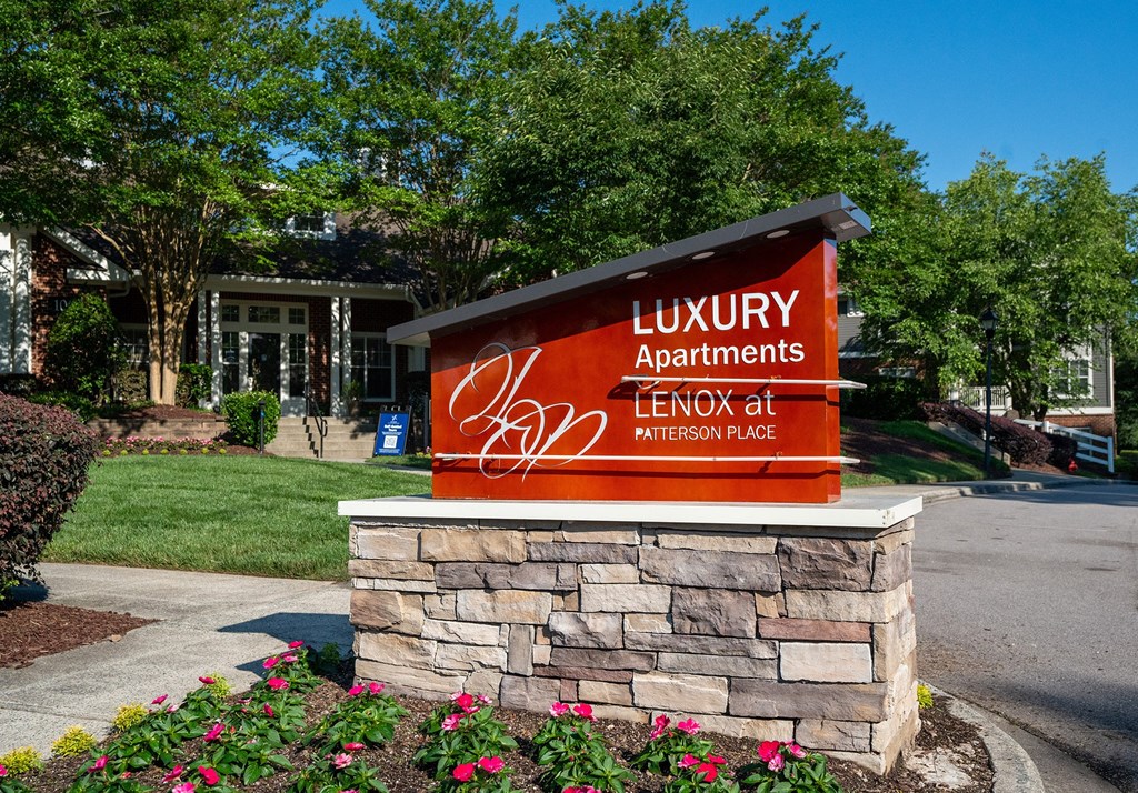 a sign for luxury apartments in front of a building