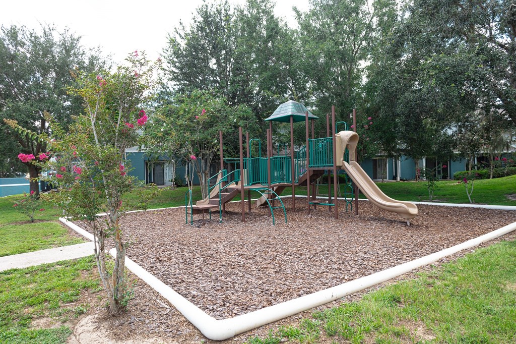 a playground with a slide and swings