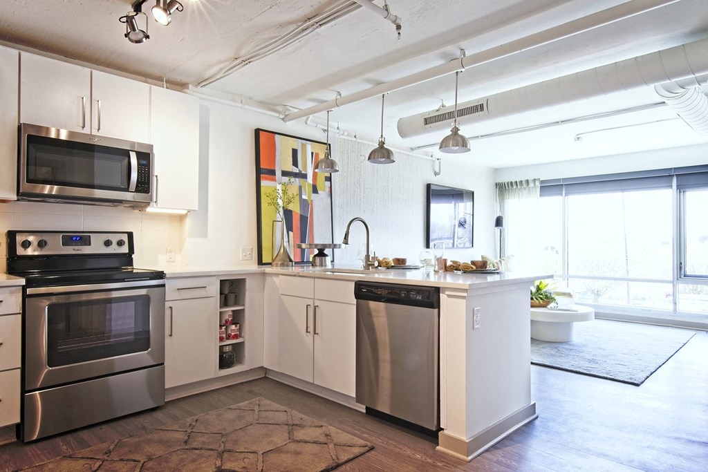 a kitchen with stainless steel appliances and white cabinets