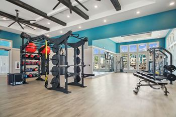 a home gym with exercise equipment and a blue wall