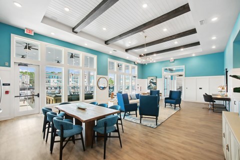 A dining room with a table and chairs.