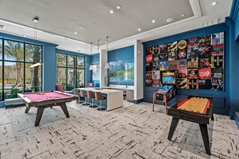 a game room with pool tables and a wall covered in posters