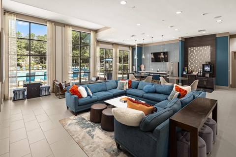 A modern living room with a large blue sectional sofa and a television.