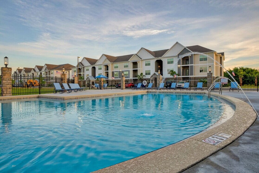 a swimming pool with apartments in the background