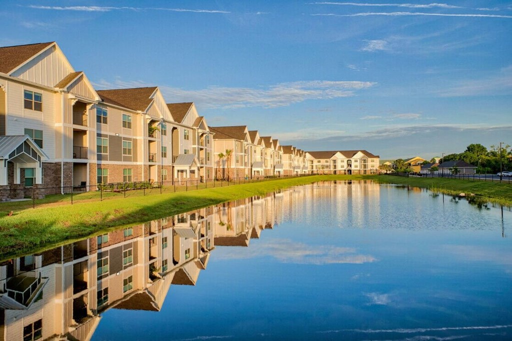 a large body of water with houses reflected in it