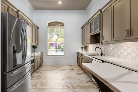 a kitchen with stainless steel appliances and marble counters