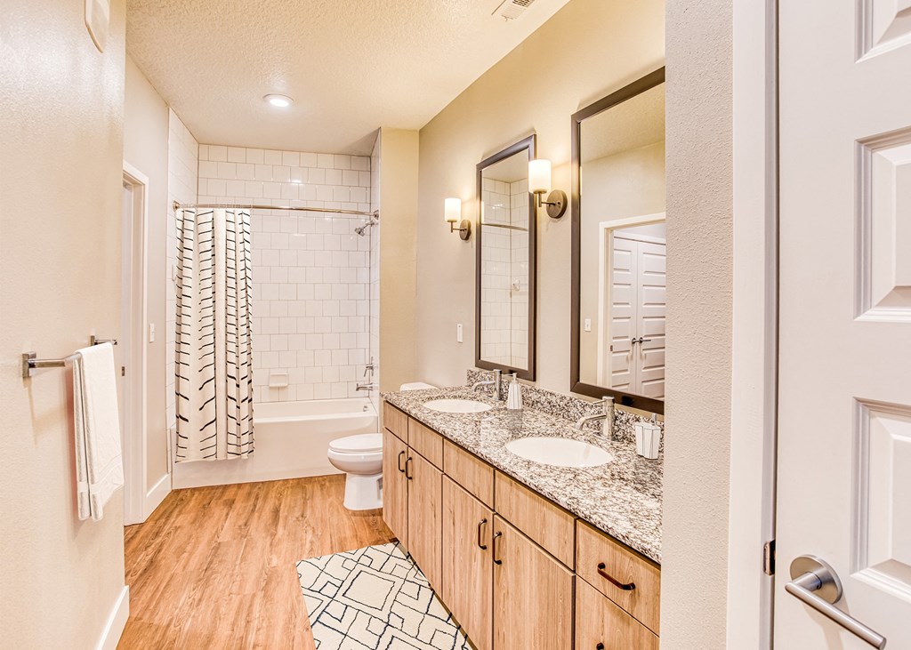 A bathroom with a toilet, sink, and shower.
