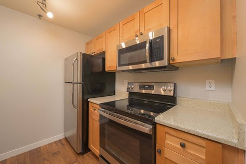 A kitchen with wooden cabinets and stainless steel appliances.