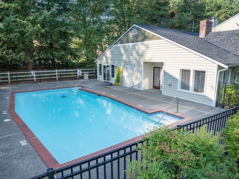 A small house with a pool in the backyard.