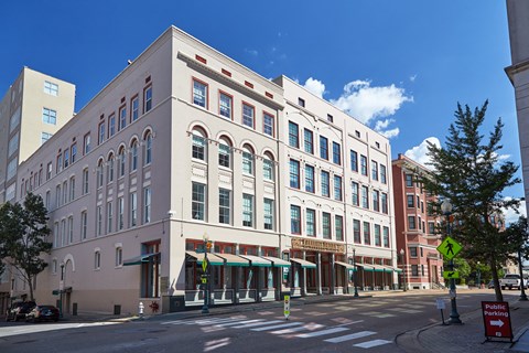 a large white building on the corner of a city street