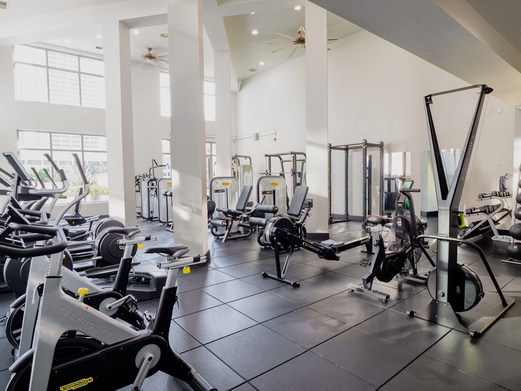 A gym with a variety of exercise equipment.