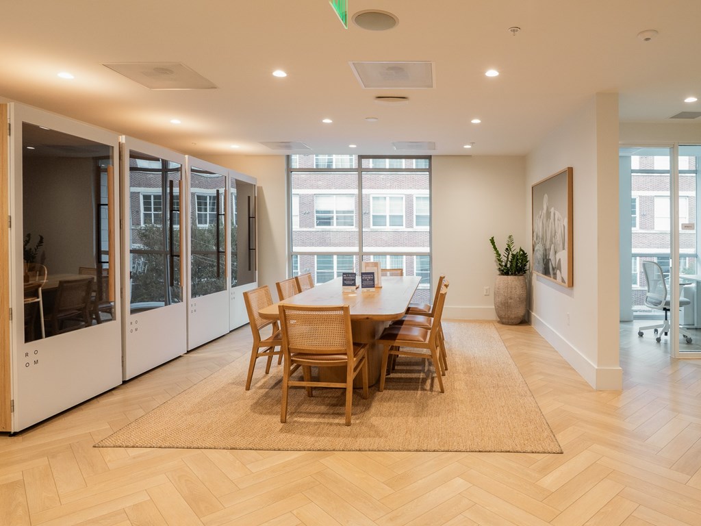 A dining room with a table and chairs.