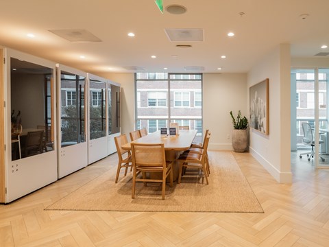 A dining room with a table and chairs.