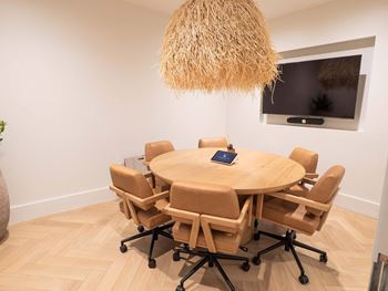 A conference room with a round table and chairs.