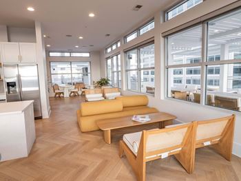 A modern living room with a yellow sofa and wooden furniture.