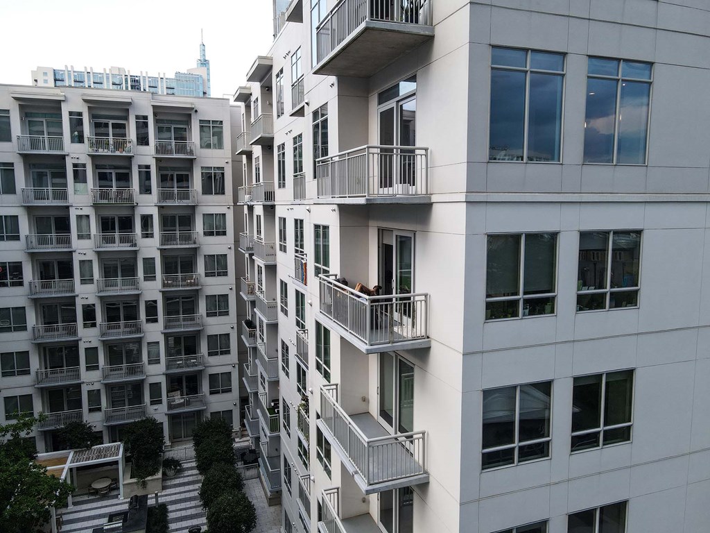 A white apartment building with balconies and windows.