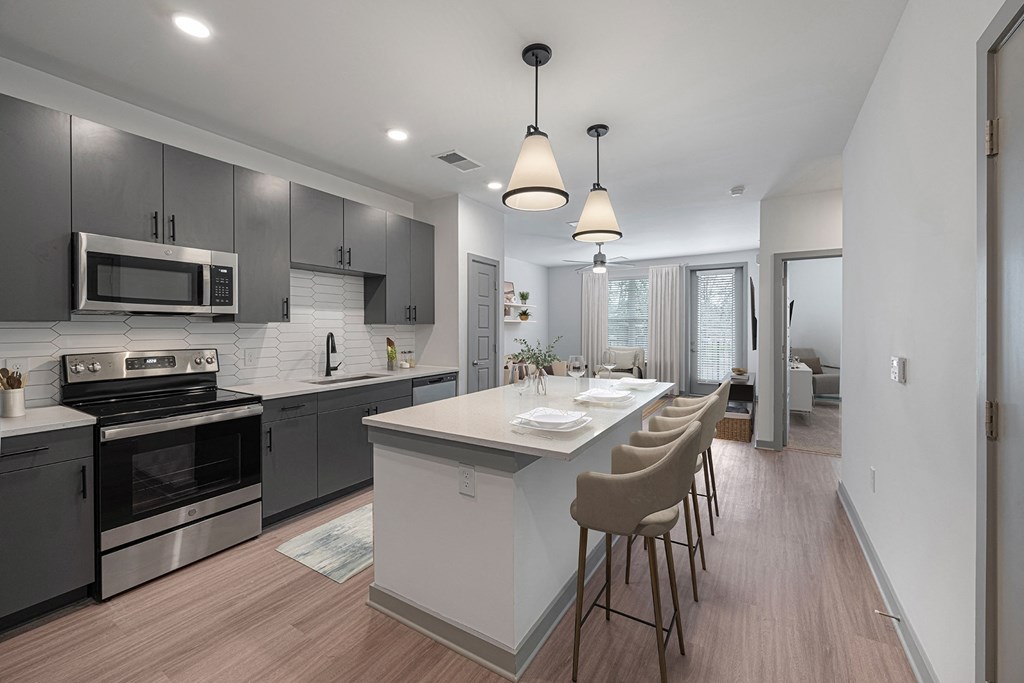 an open kitchen and dining area with a large island and a table with chairs