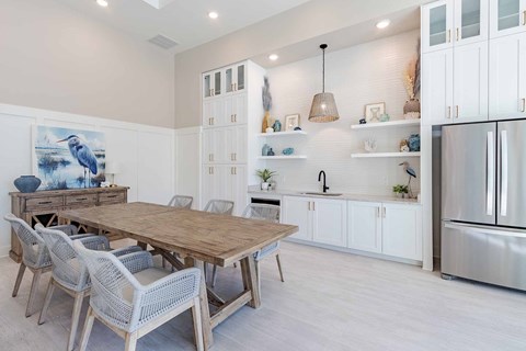 A modern dining room with a wooden table and chairs.
