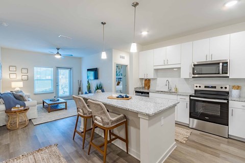 A modern kitchen with white cabinets and stainless steel appliances.