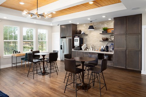 a kitchen and dining room with a table and chairs