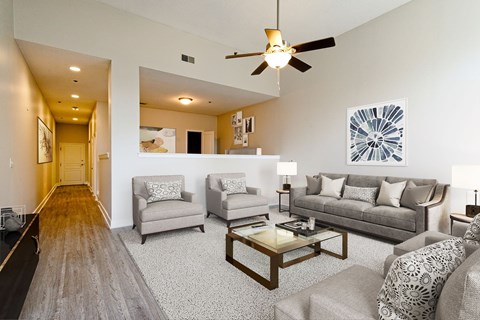 A living room with a grey couch and a coffee table.