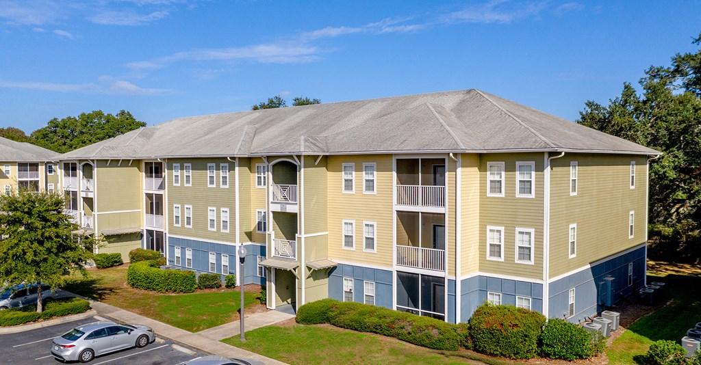 an aerial view of an apartment building with a car parked in front