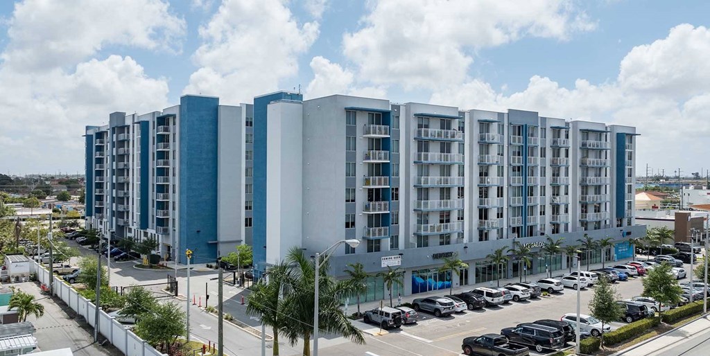 A large building with a parking lot in front of it.