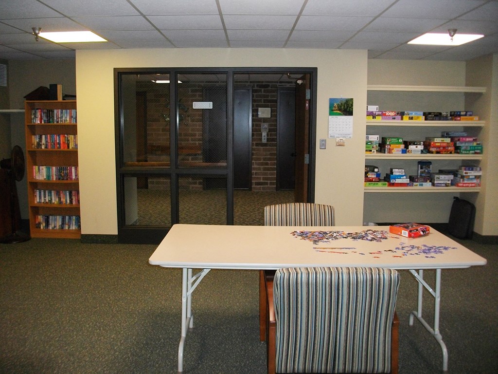 an empty library with a table and chairs