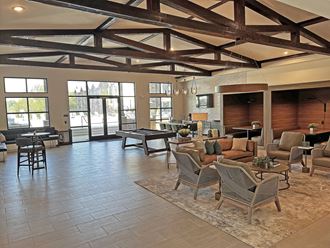 a large lobby with a pool table and lounge chairs - Photo Gallery 2