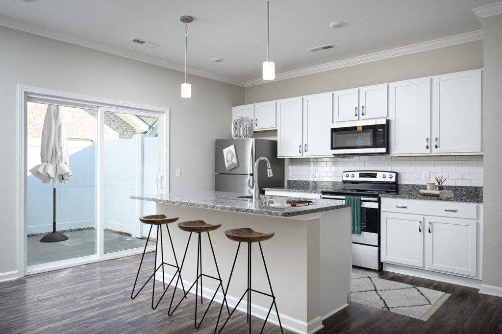 a kitchen with white cabinets and a counter top