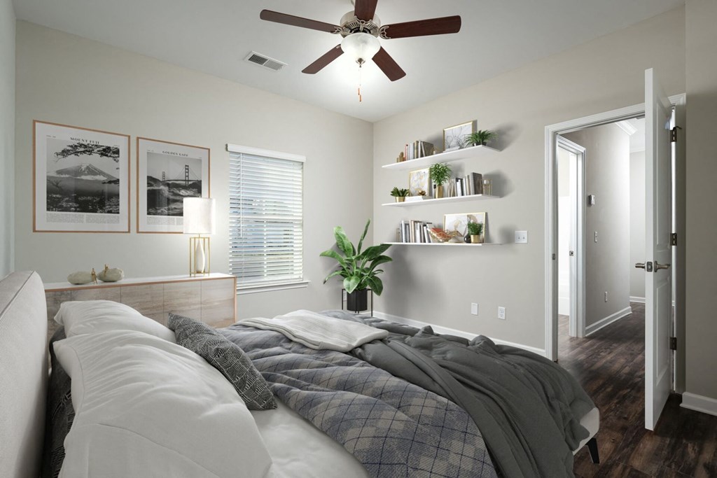 a bedroom with a large bed and a ceiling fan