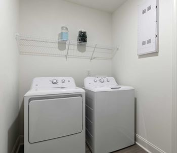 A small laundry room with a washer and dryer.