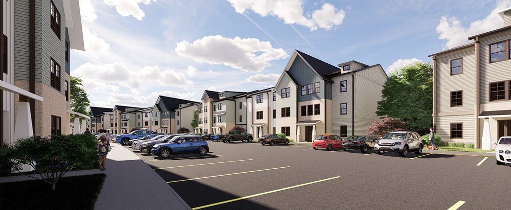 West Oakland Park, TN, Luxury Apartments with In-Unit Washer and Dryer - Vintage Johnson City -  Parking Area Surrounded by Multiple Three-Story Buildings and a Wide Sidewalk.