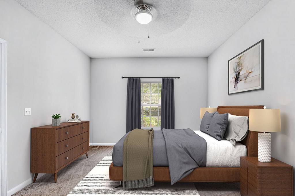 A bedroom with a bed, nightstand, and window with curtains.