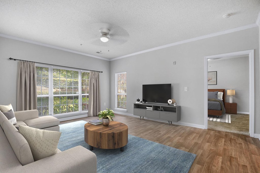 A living room with a television, a couch, and a coffee table.